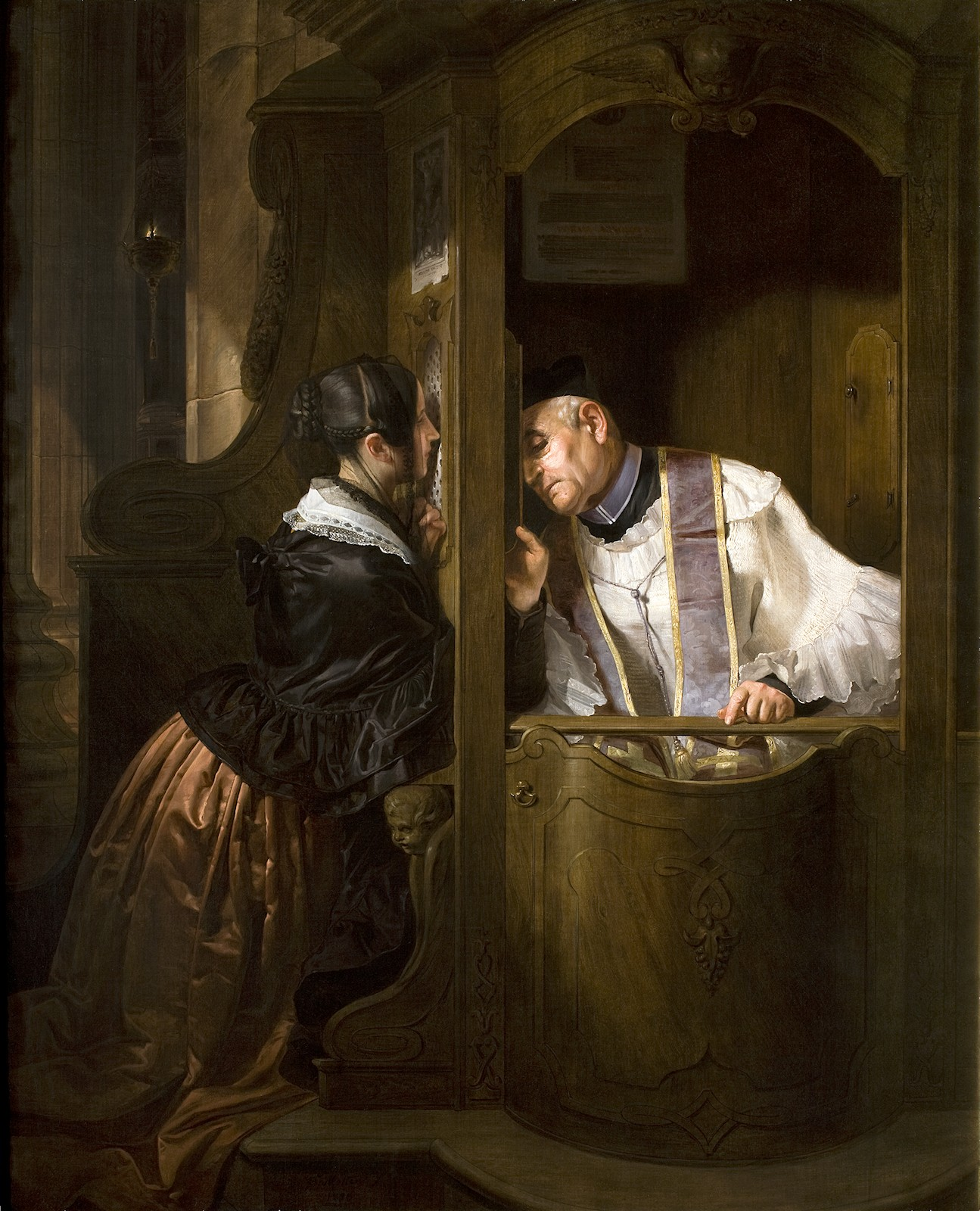 Priest hearing confession in the confessional
